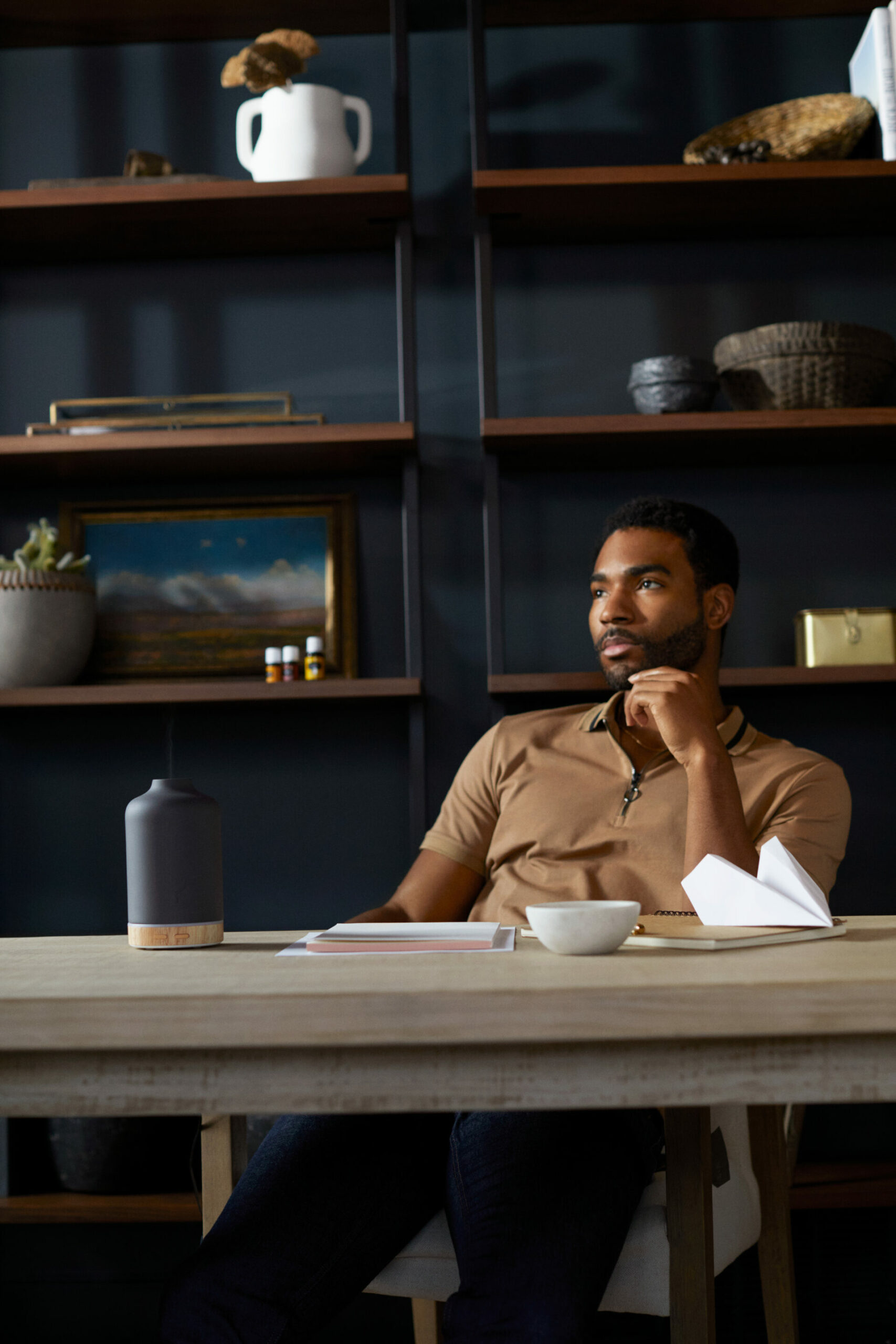 Man looking thoughtfully at desk