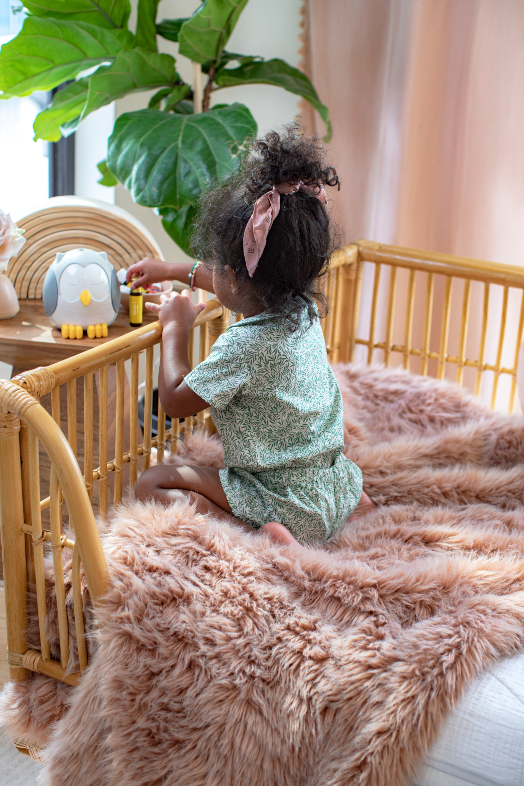 Girl playing with snowy the owl diffuser