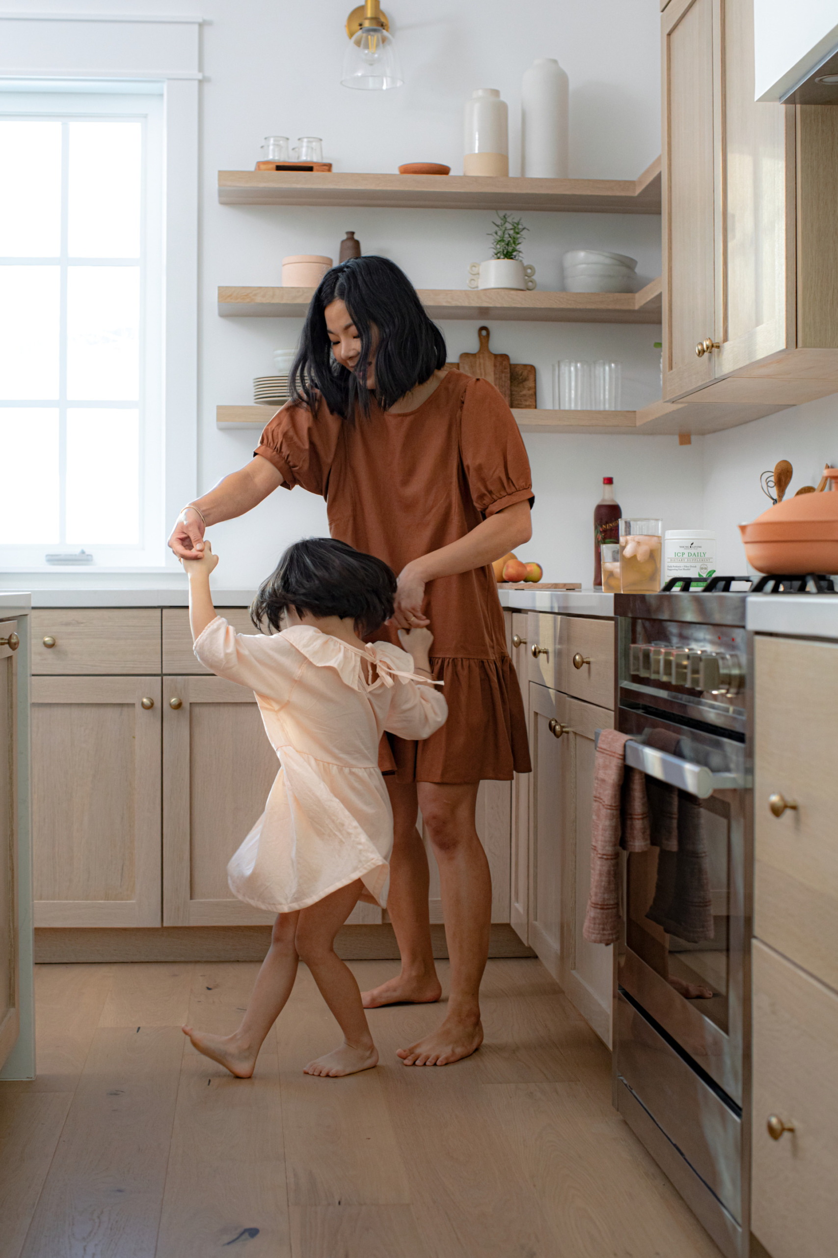 Mother and daughter dancing in the kitchen