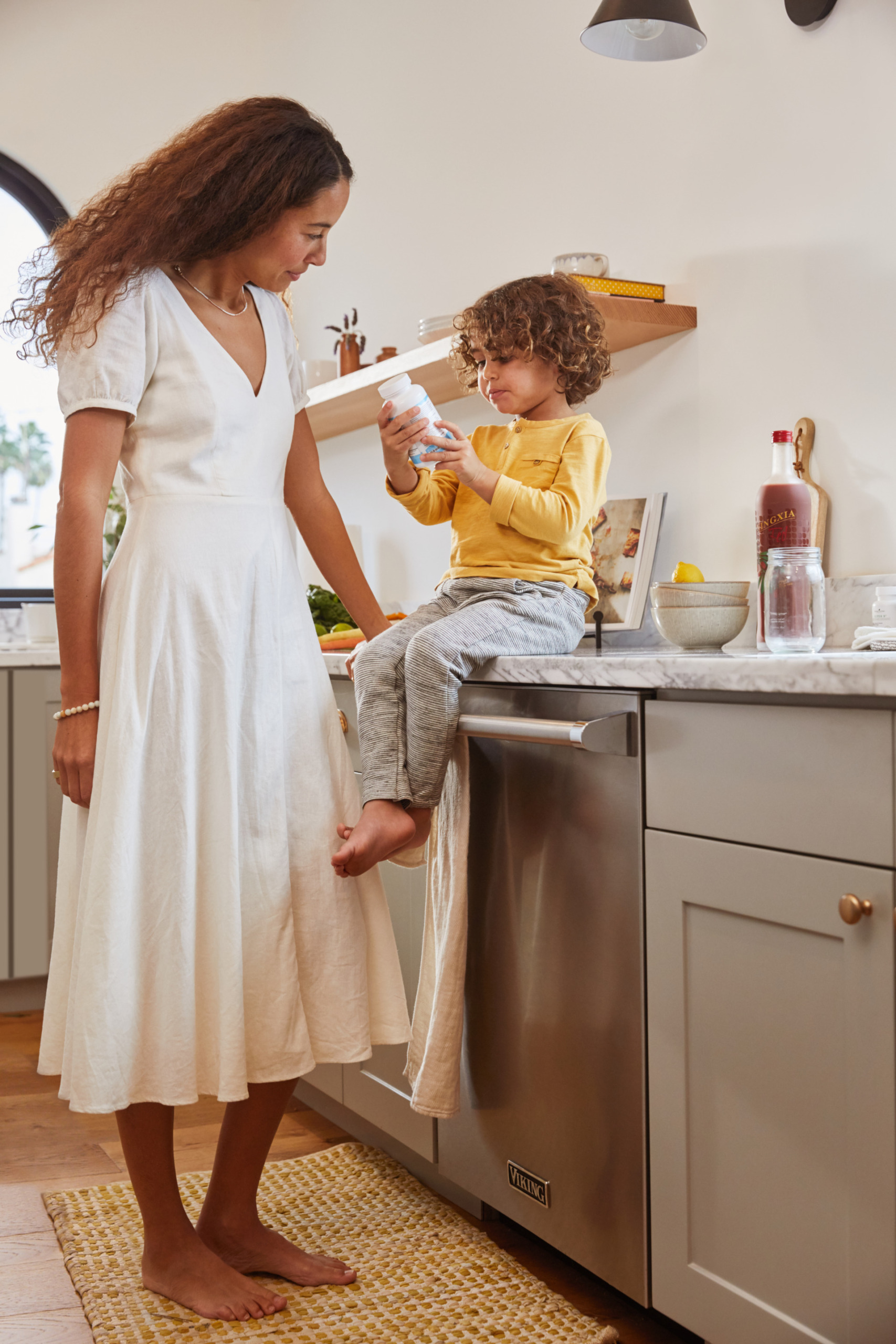 Mom and kid in the kitchen with supplements