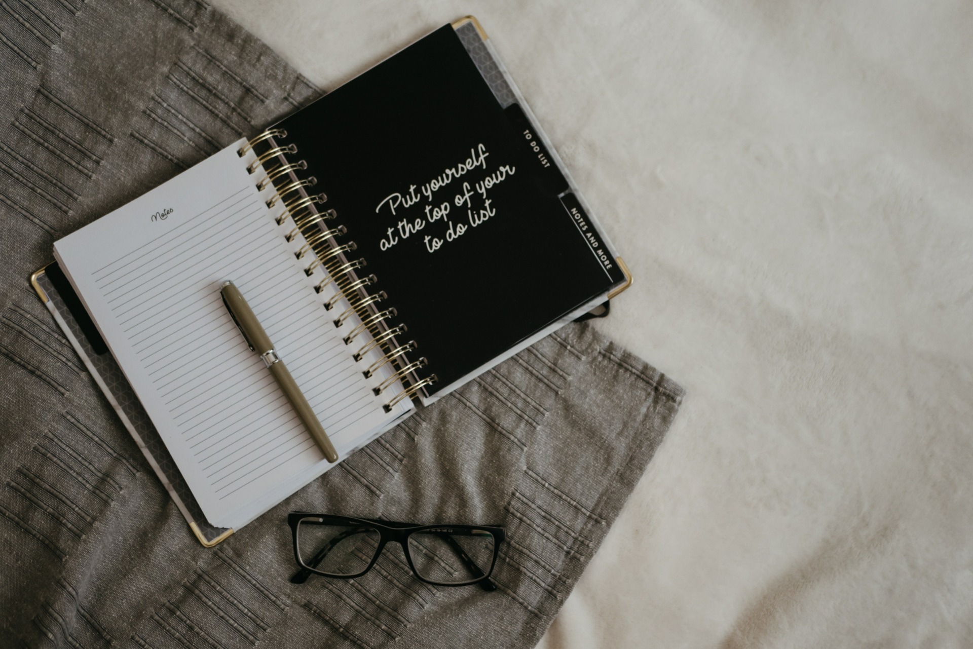 Journal and pen on a bed