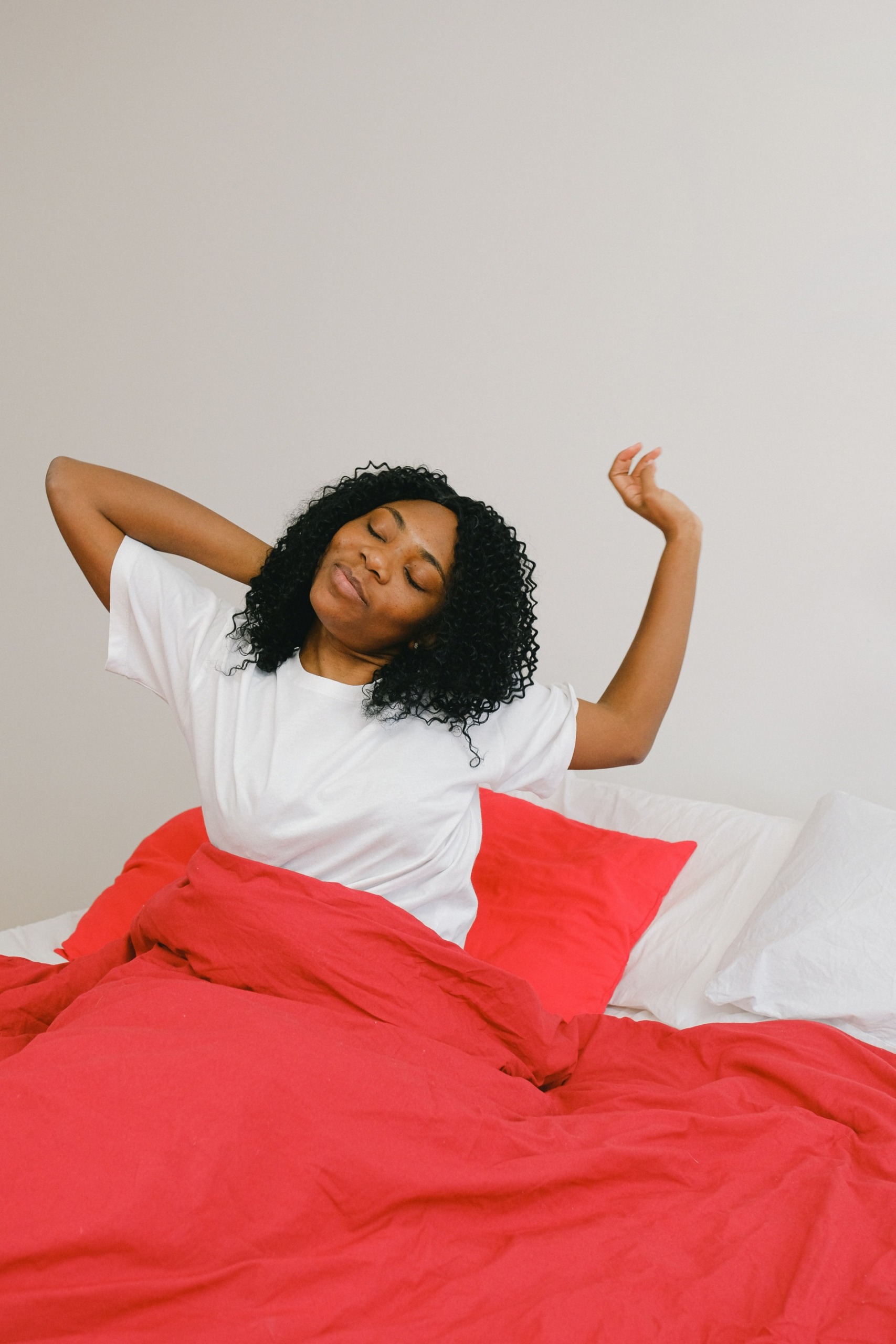 Woman stretching in bed