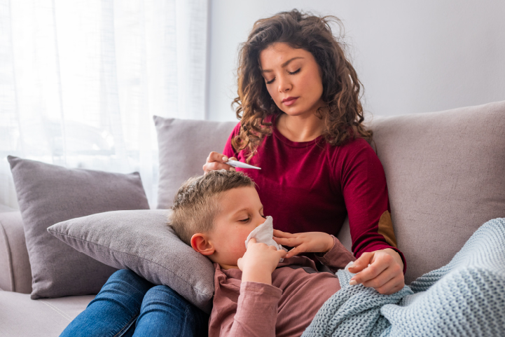 mom helping her sick coughing child