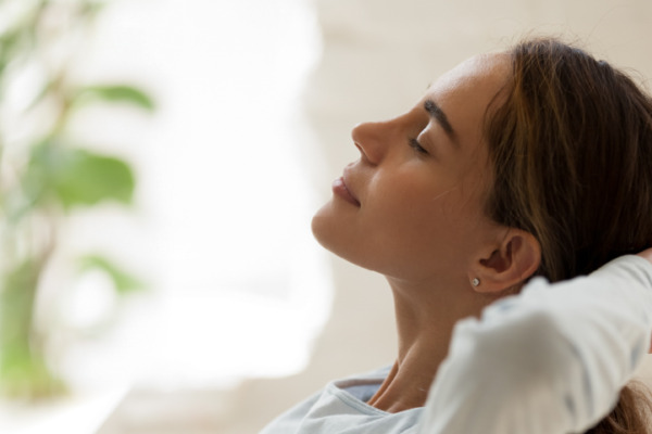 woman sitting down relaxing to destress