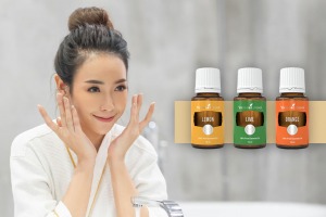 Woman doing evening skincare with Lemon, Lime and Orange essential oils
