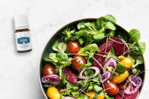 Oregano+ essential oil with bowl of salad