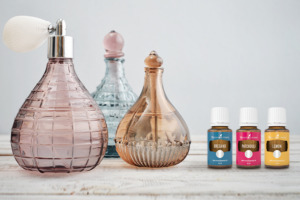 Oregano, Patchouli and Lemon essential oils with perfume bottles