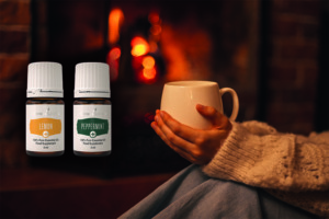Lemon+ and Peppermint+ essential oils with evening cup of tea in front of fireplace