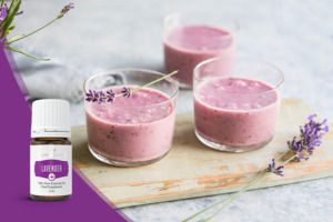 Fruchtiger rosafarbener Smoothie im Glas mit Lavendelzweig und Lavender+ ätherisches Öl der Pluslinie von Young Living