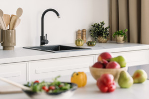 Fruit and salad on kitchen worktop with sink in background