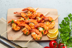 Grilled Prawns on Skewers with Lemon Slices and Tomatoes