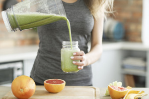 Woman pouring homemade smoothie