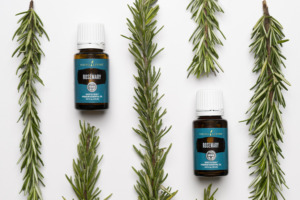 Image of Rosemary essential oil with sprigs of fresh rosemary.