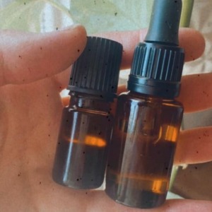 Image of essential oil bottles (labels removed) being refilled and reused.