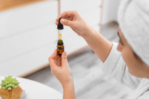 Image of woman blending essential oils.