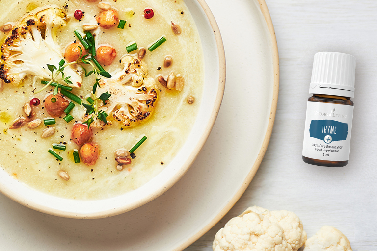 Image of a bowl of creamy cauliflower soup with Thyme+ essential oil.
