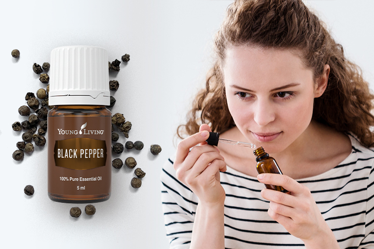Image of a woman concocting an essential oil blend using Black Pepper essential oil