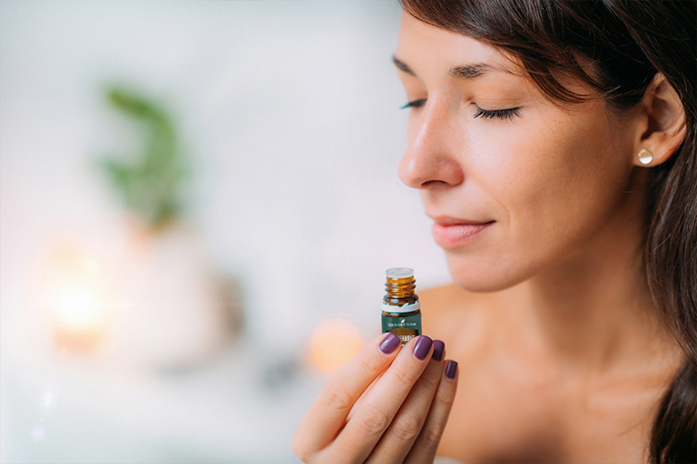 Image of a woman inhaling Peppermint essential oil.