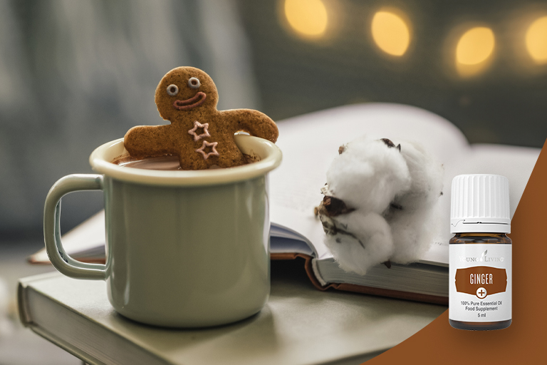 Bild des ätherischen Öls Ginger+ und heißer Schokolade garniert mit einem Lebkuchenmännchen.
