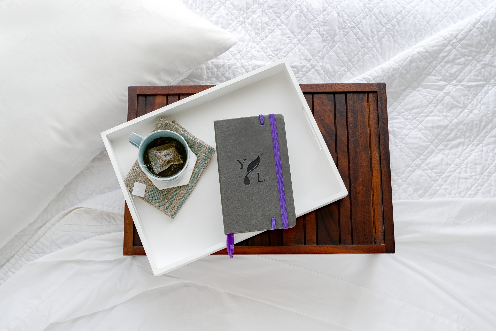2018SeptemberHelp5_BeautyImage1_US Young Living Journal on a bed