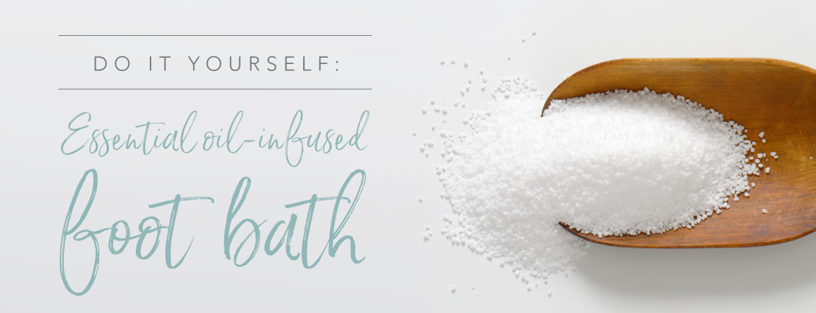 Do it yourself essential oil infused foot bath. Epsom salt in a scoop on a white background