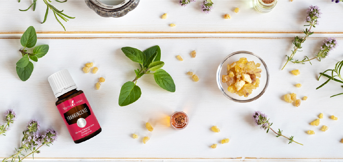 Frankincense essential oil on a table top with botanicals for grounding and mindfulness