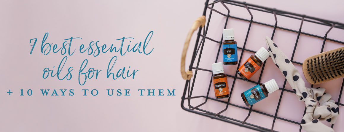 Essential oils in a wire basket on a blush background- Essential oils for hair
