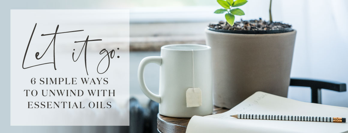 a mug and a notebook on a table in front of a window