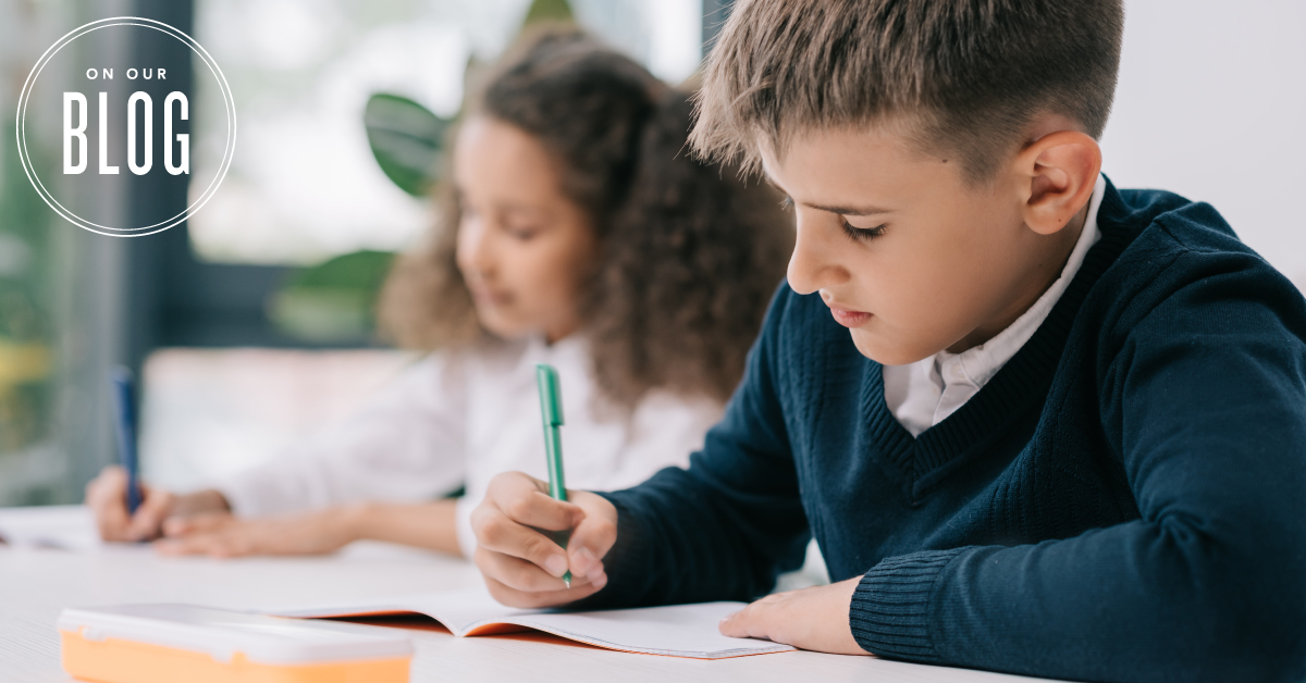 students writing on a notebook prepping for school