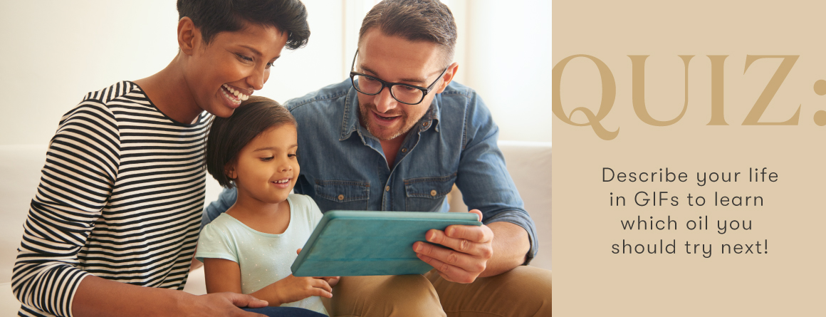 A family laughs together playing a game on a tablet