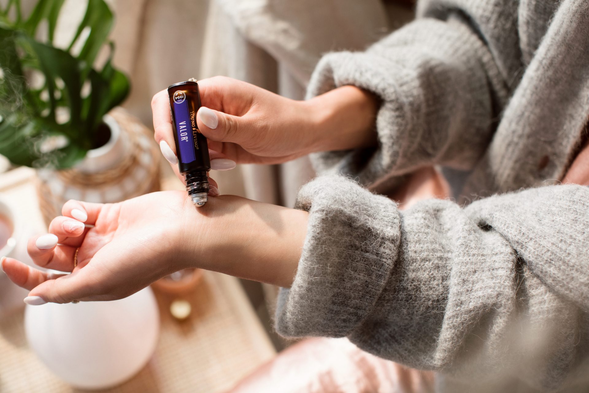 YL_Lifestyle_Peace in the Moment_132 Young Living essential oil Valor roller being applied to wrist