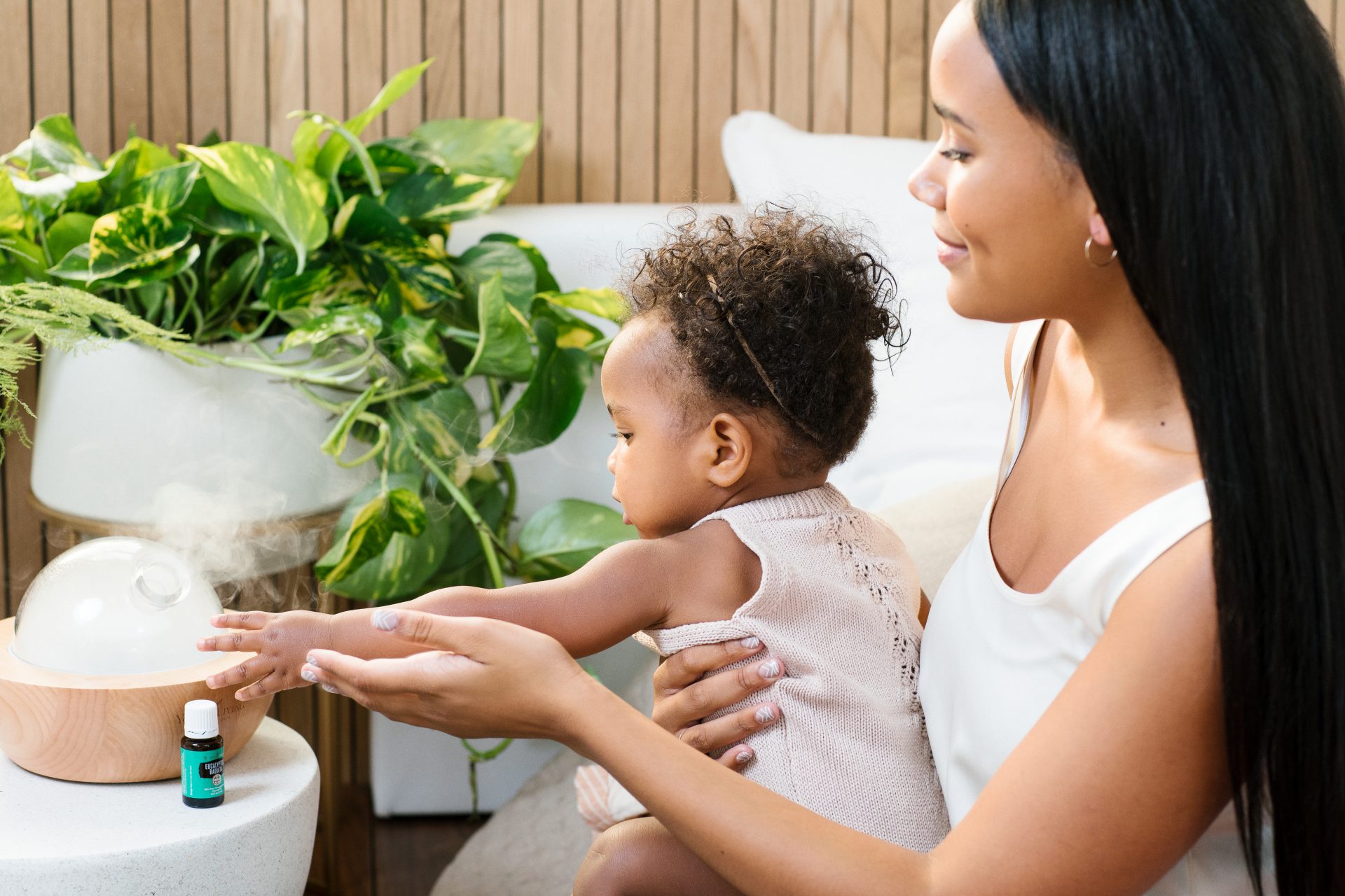 YL_Lifestyle_Caring Moment_196 Young Living essential oil diffuser with a Mom and Baby