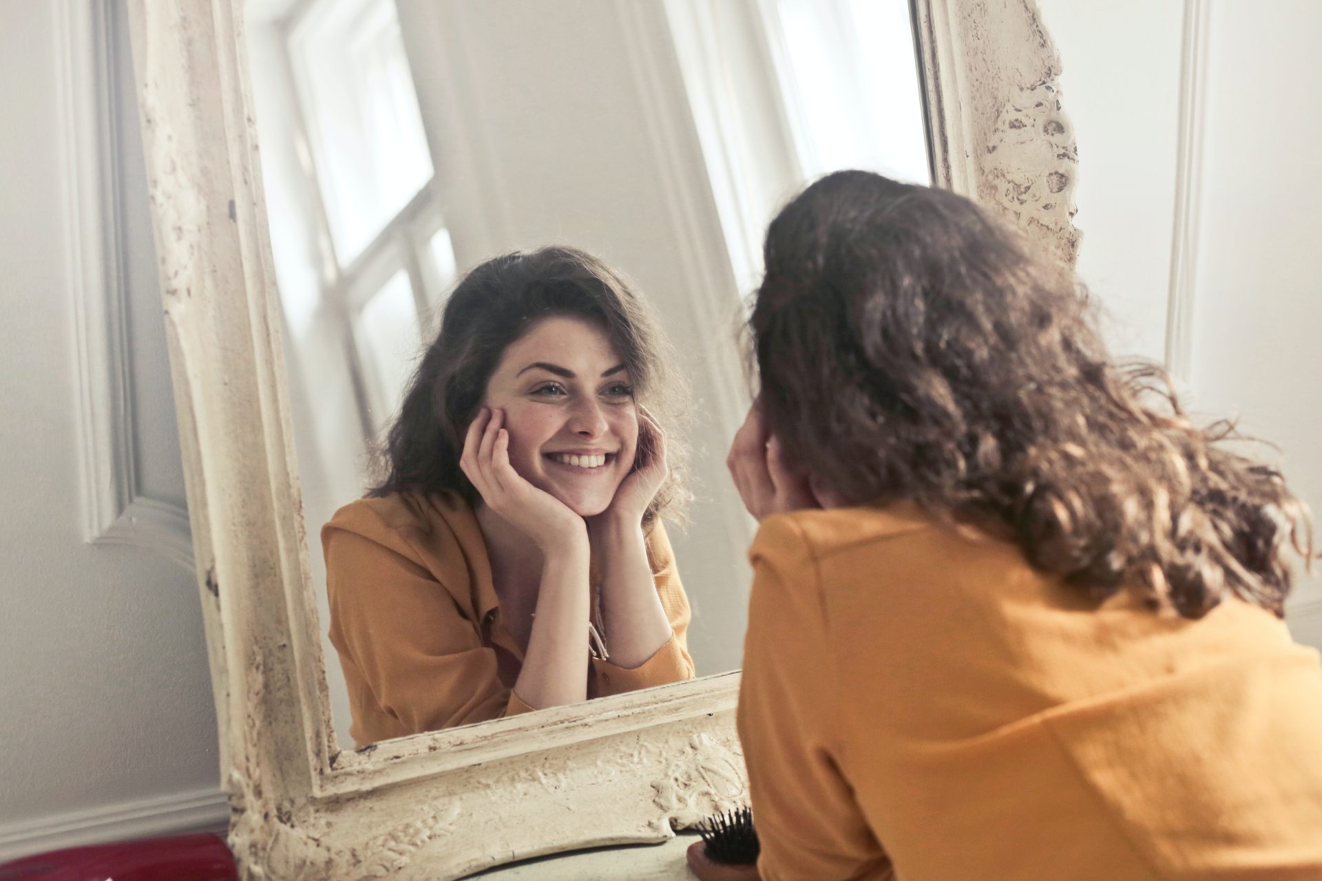 Woman looking in the mirror - Photo by Andrea Piacquadio from Pexels - Young Living Lavender Life Blog 