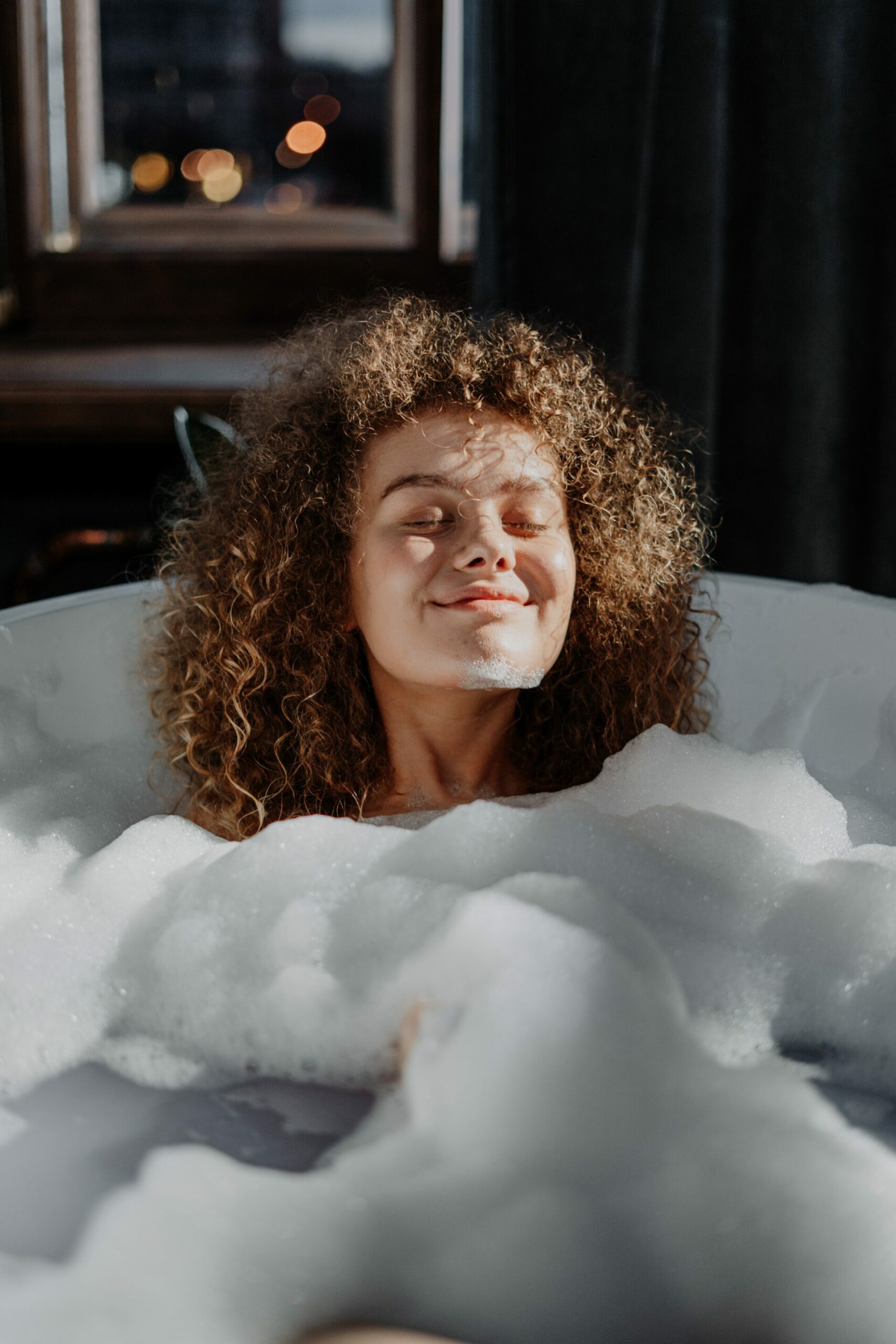 Woman sitting in bubble bath - Young Living Lavender Life blog 