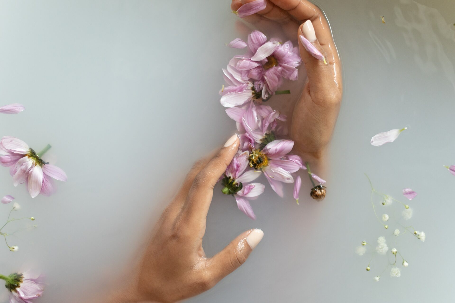 pexels-monstera-6621225 Hands in bath with flower petals - Young Living Lavender Life blog