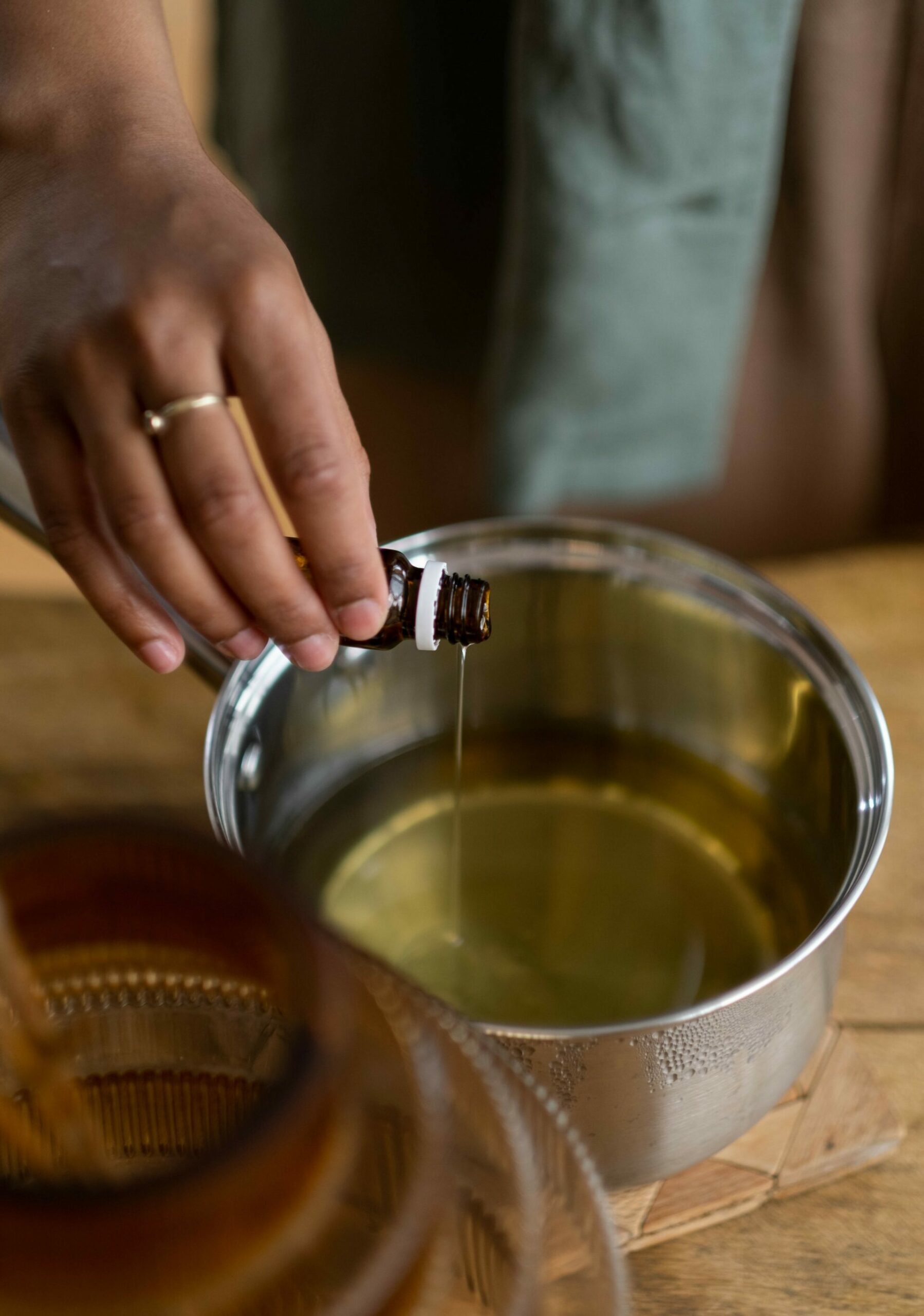 pexels-ron-lach-8271826 Pouring essential oils into a kitchen pot - Young Living Lavender Life blog