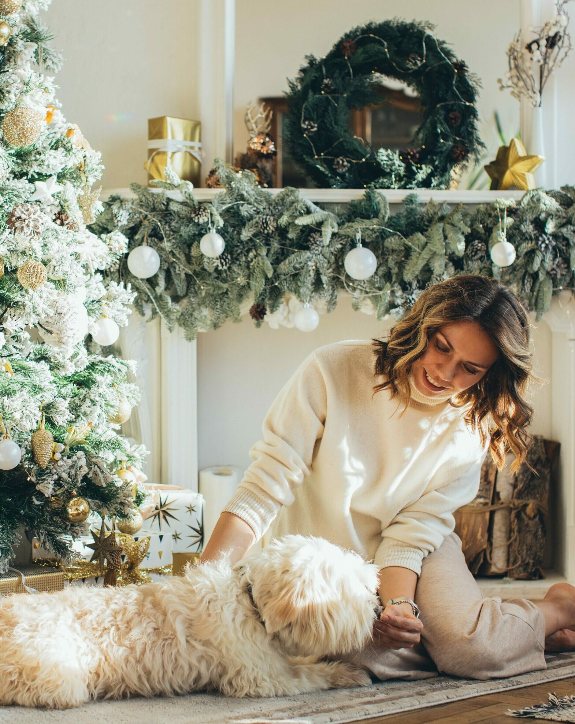 Woman hugging dog near Christmas tree - Young Living Lavender Life Blog 