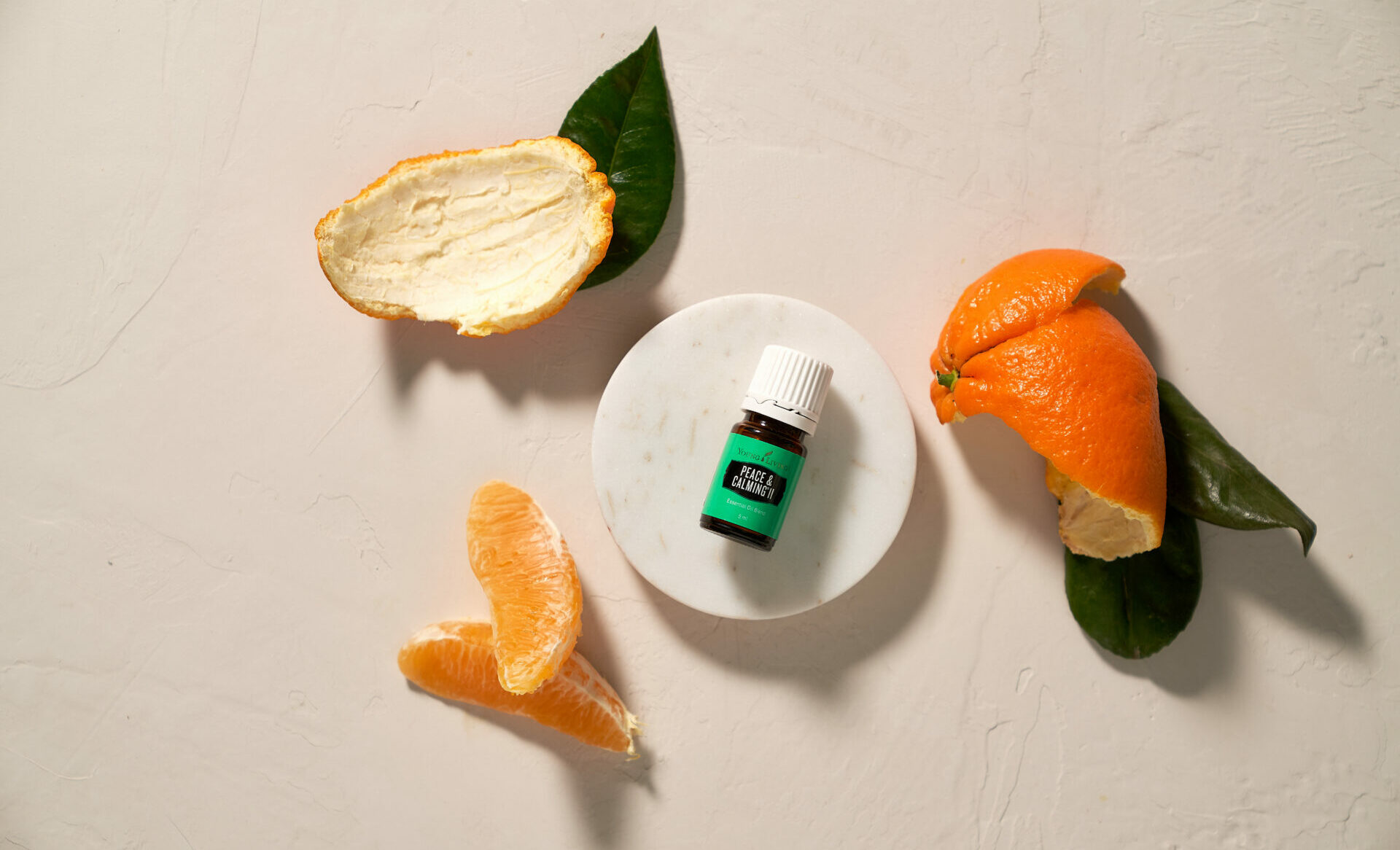 Peace&Calming PeaceandCalming and Peace & Calming II essential oil next to orange slices and peel - Young Living Lavender Life blog