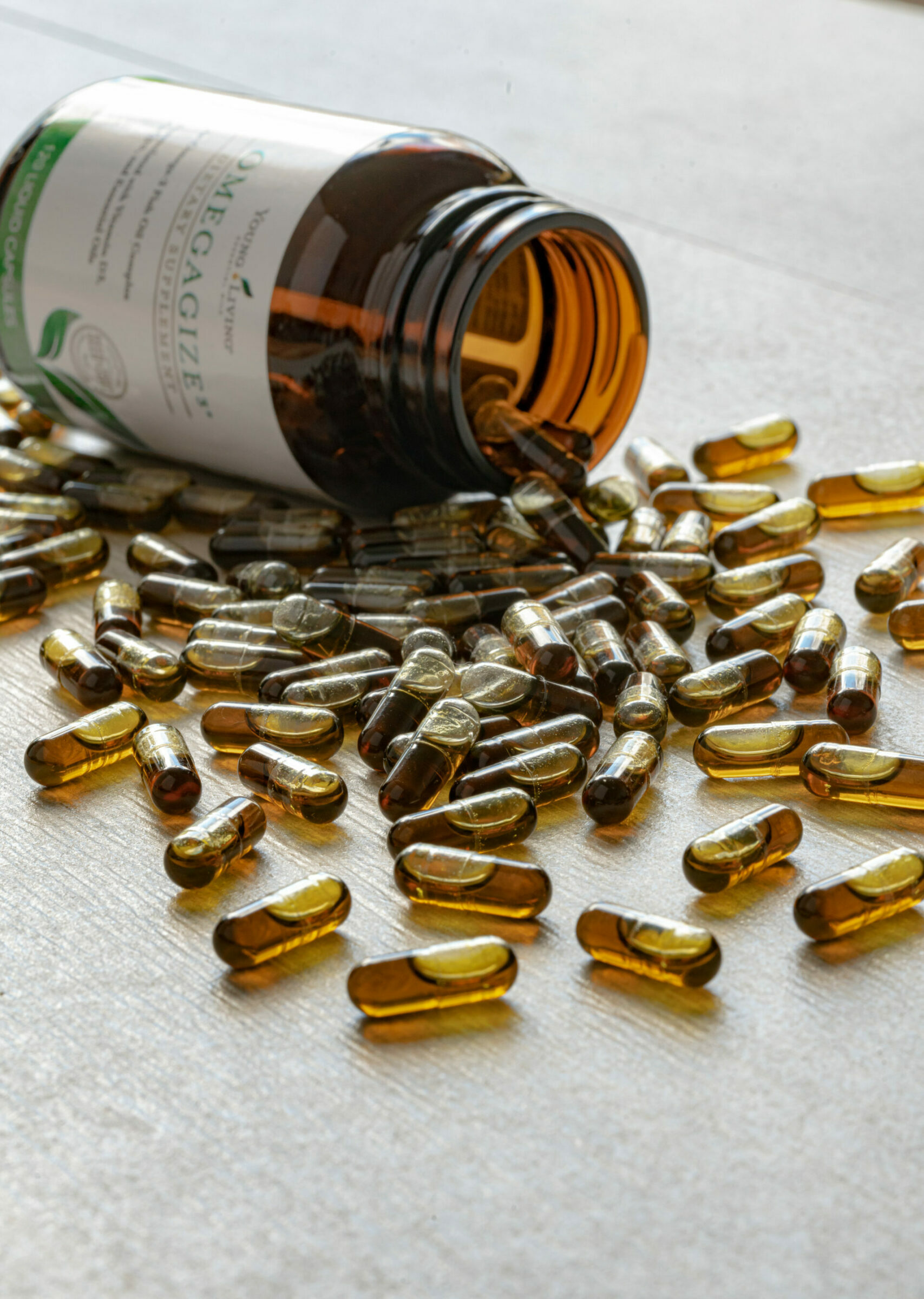 OmegaGize pills spilled out on surface next to bottle - Young Living Lavender Life Blog 