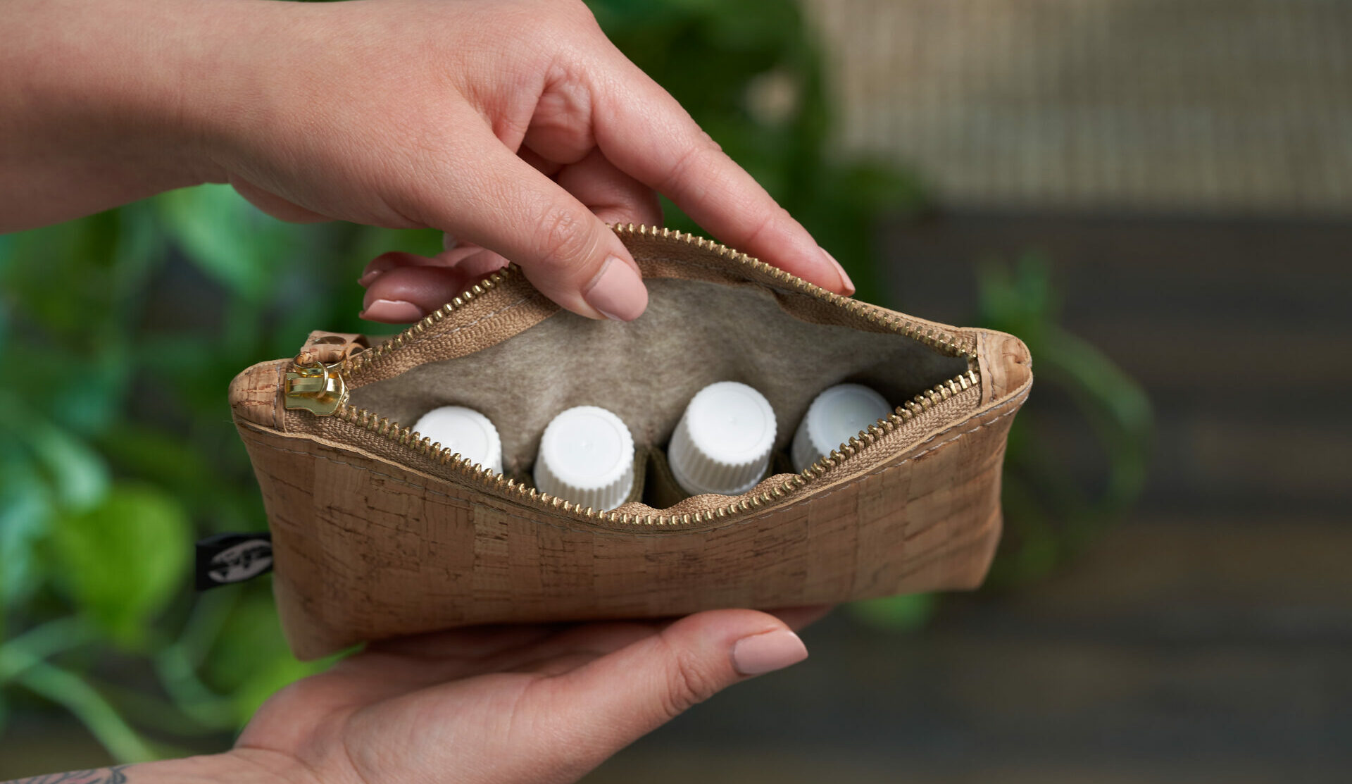 Person holding cork back with essential oils inside - Young Living Lavender Life Blog