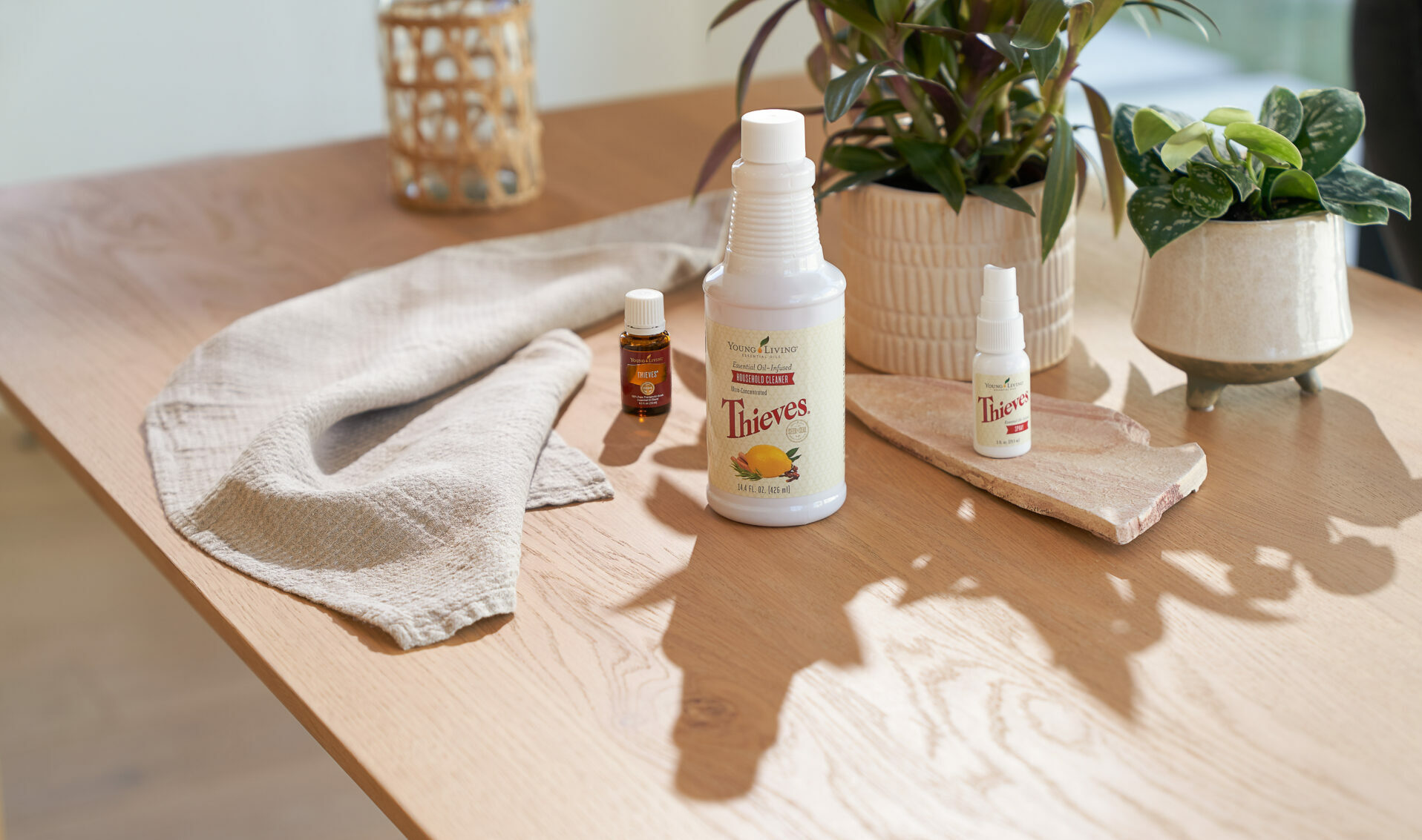 Thieves Household Cleaner, Thieves Essential Oil, and Thieves Spray sitting on countertop - Young Living Lavender Life Blog 