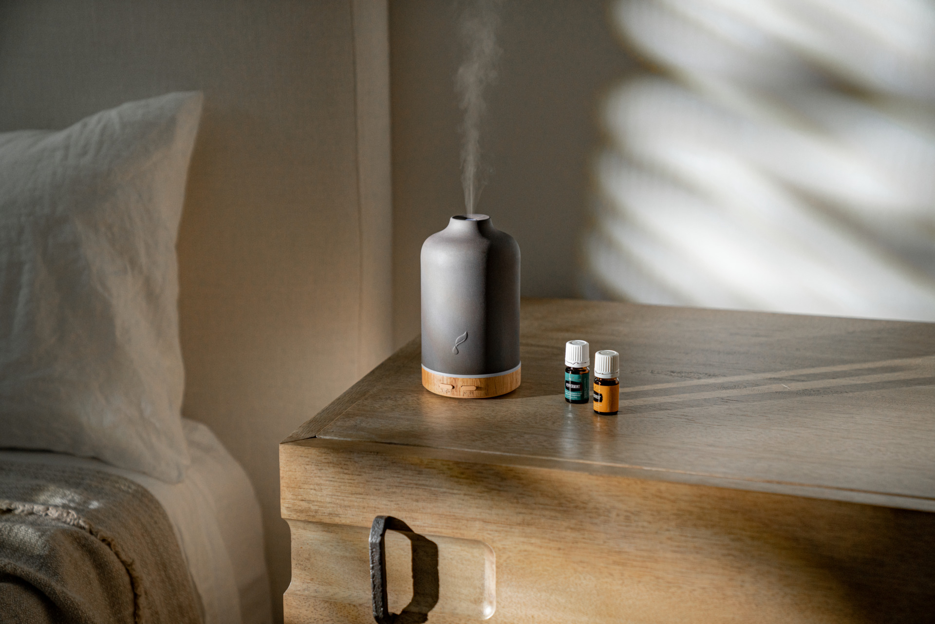 Ember diffuser by the bedside with young living essential oils 