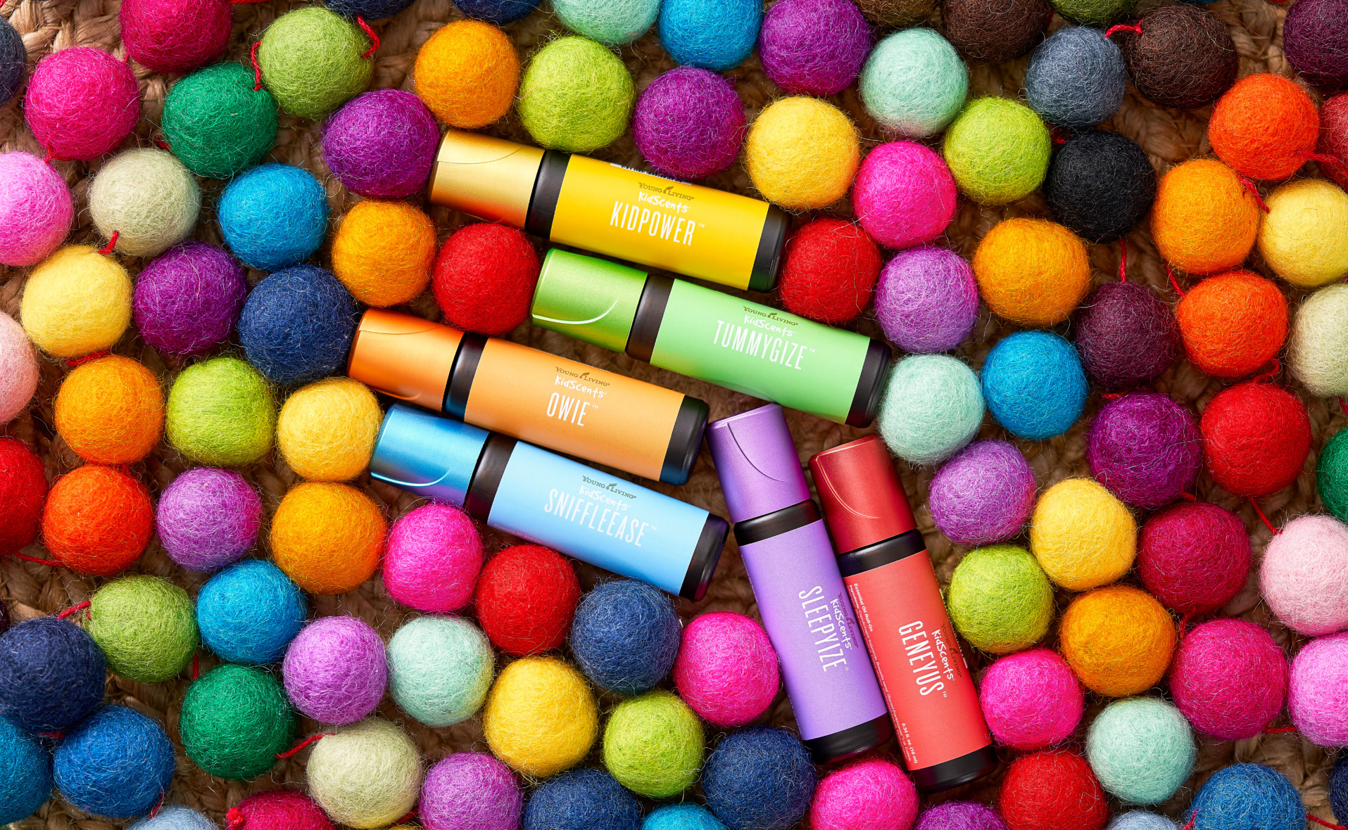 KidScents Roll-Ons surrounded by colorful felt balls - Young Living Lavender Life Blog 