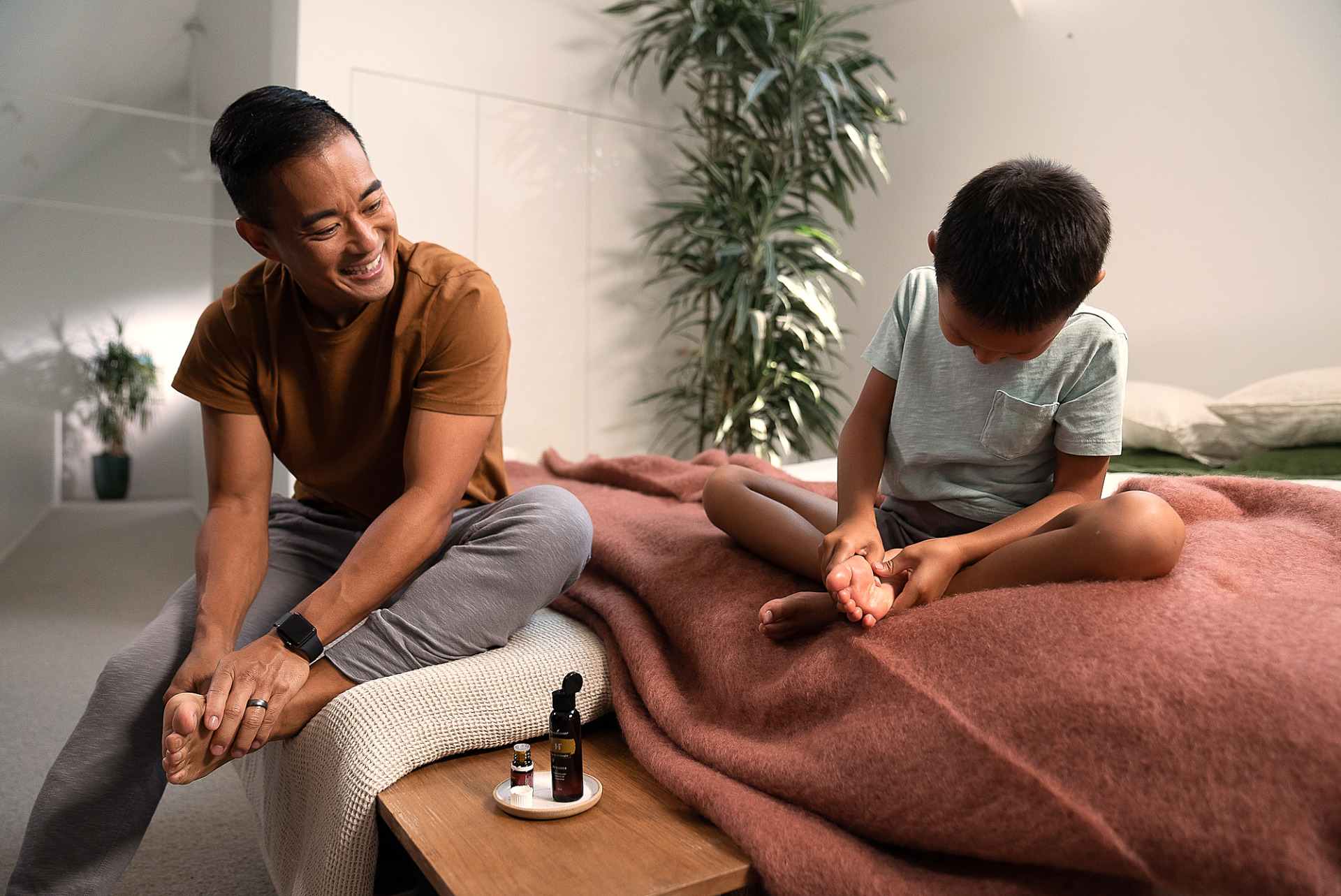 Father and son doing essential oil foot massages - Young Living Lavender Life Blog 