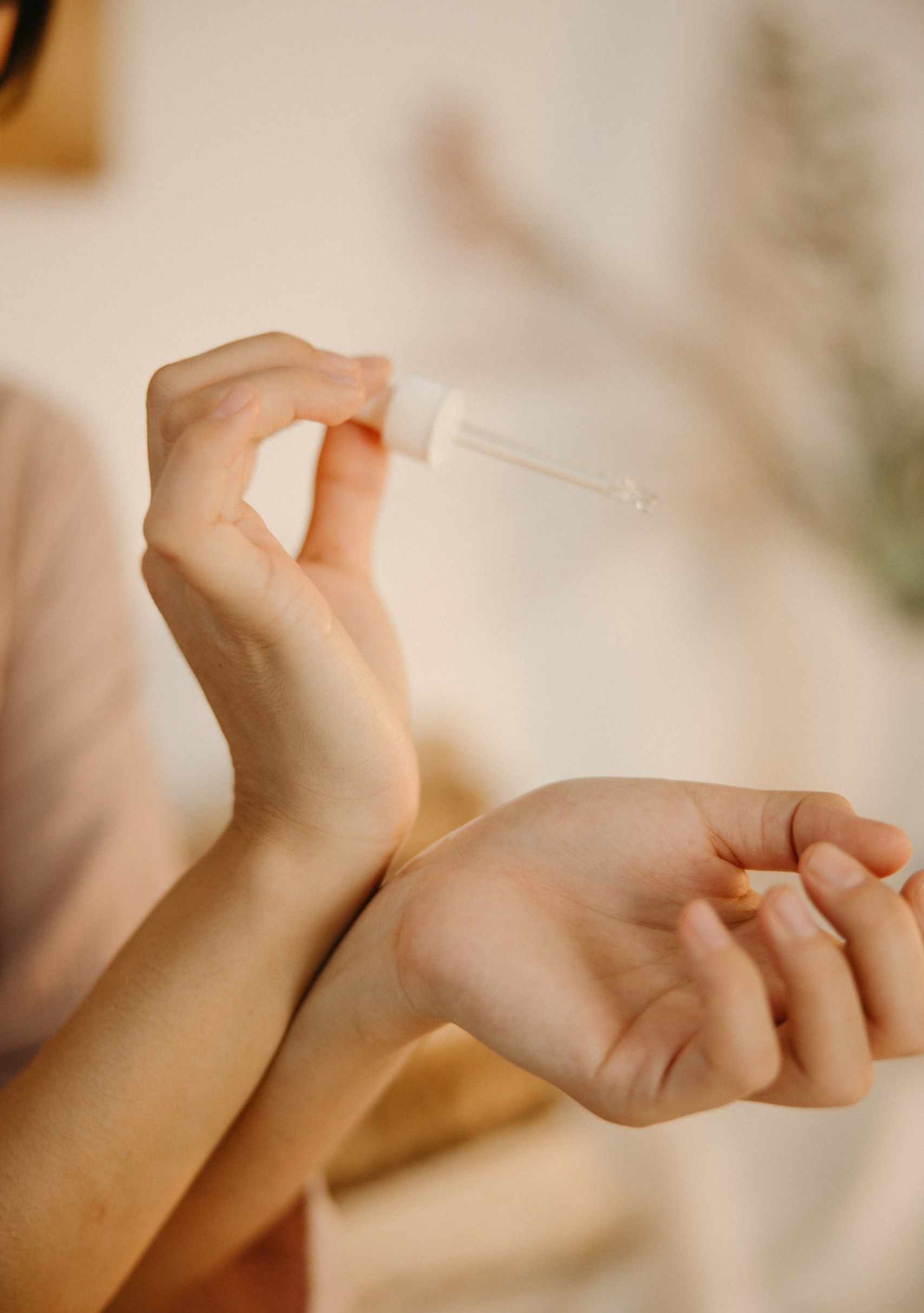 Woman applying oil to skin to patch test - Young Living Lavender Life Blog