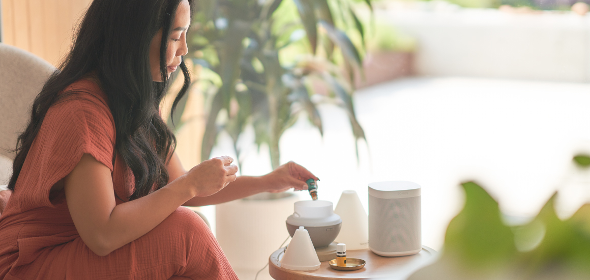 Woman putting essential oils in a diffuser