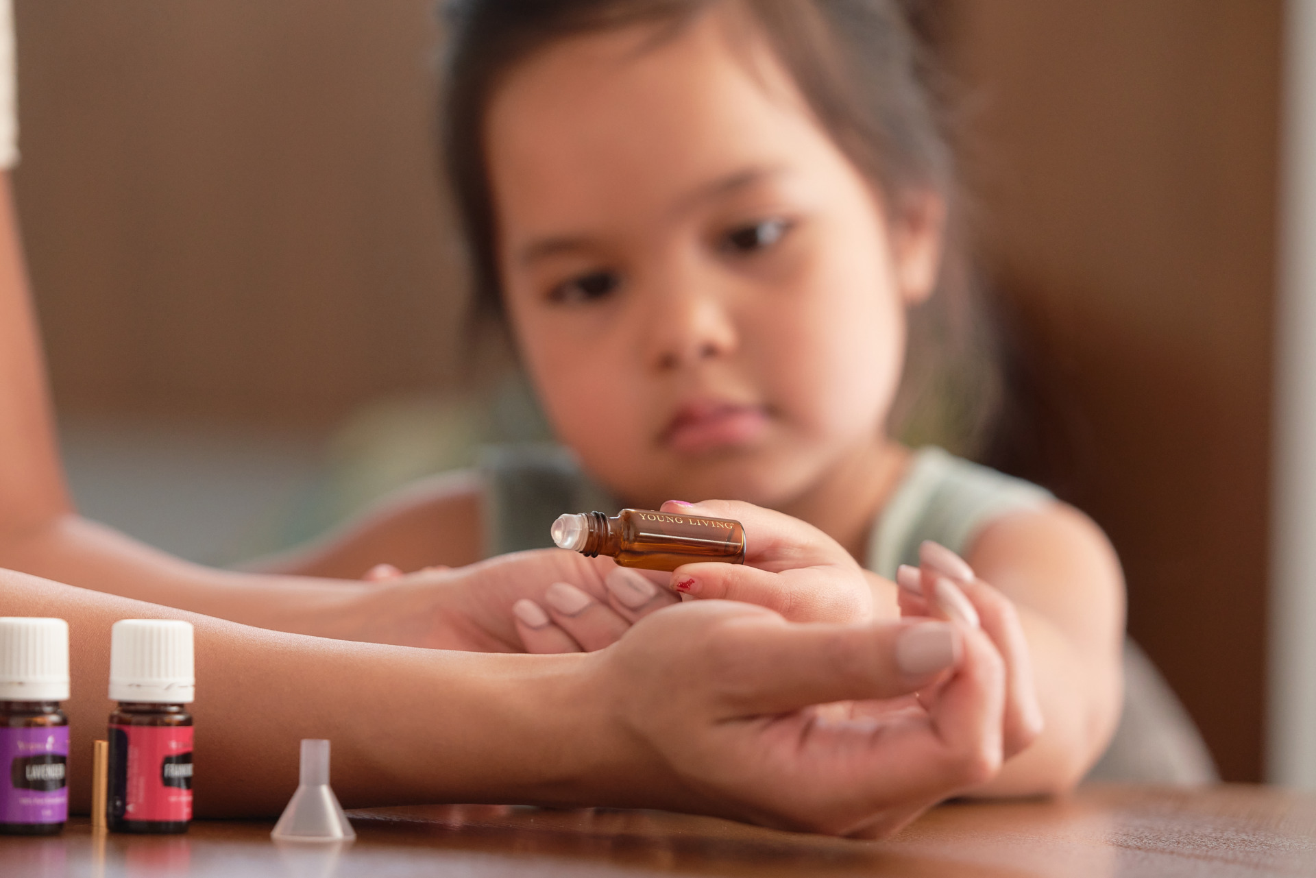 Little girl and mom making DIY essential oil roller - Young Living Lavender Life Blog 