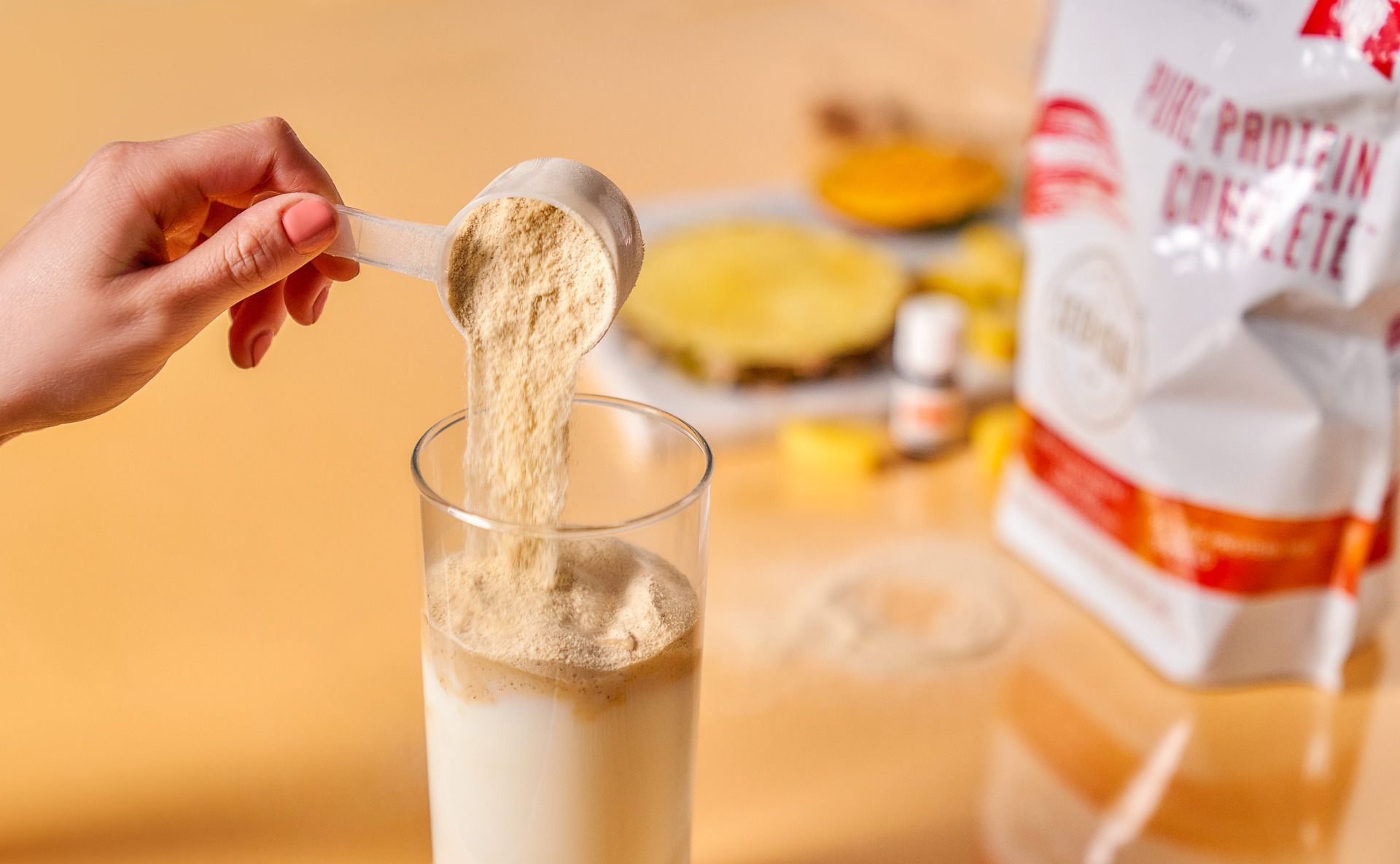pureproteincompletevanillaspice Pouring protein powder into cup - Young Living Lavender Life Blog