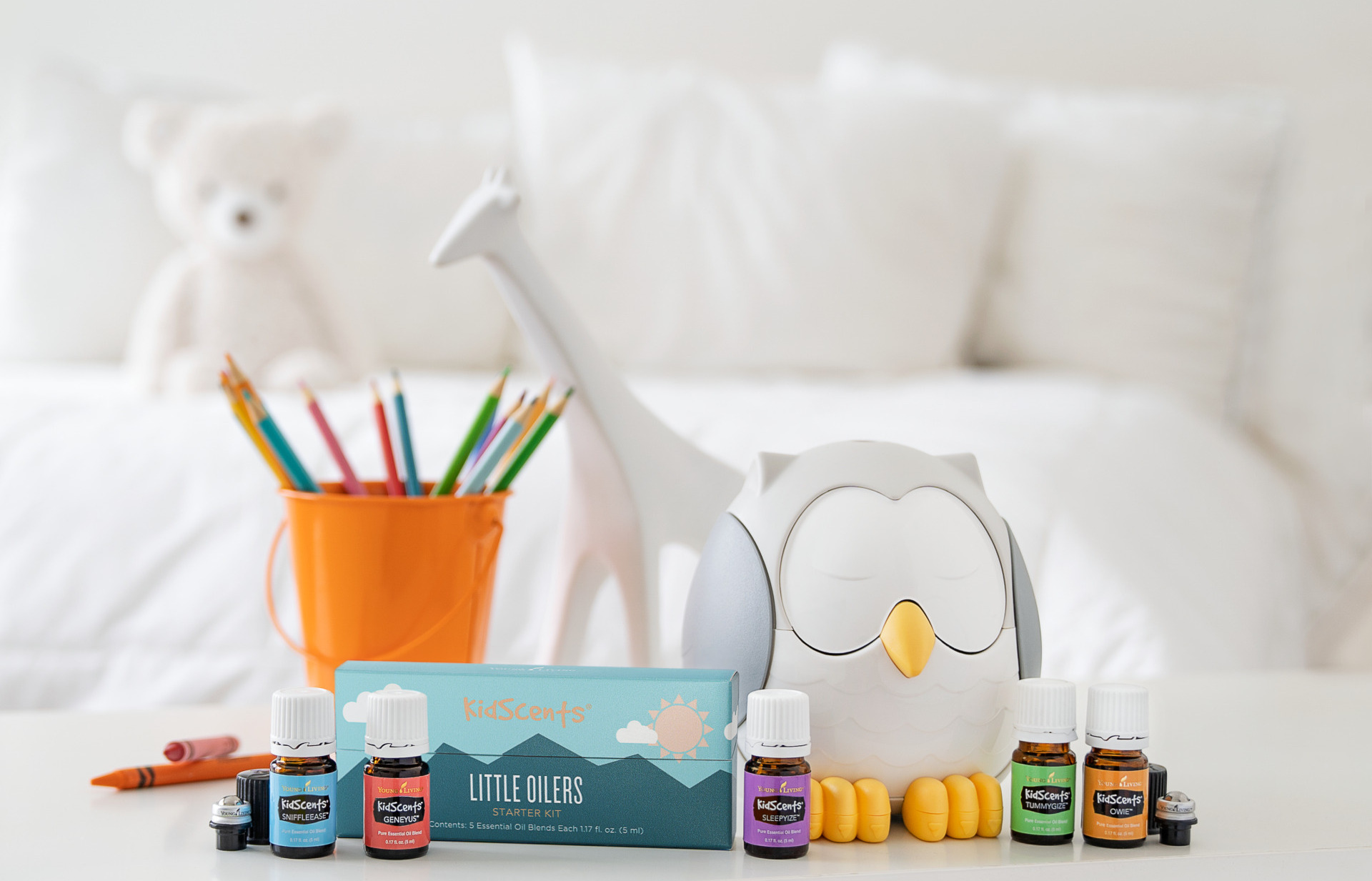 Young boy diffusing essential oils using Feather the Owl Diffuser on bedside table - Young Living Lavender Life Blog