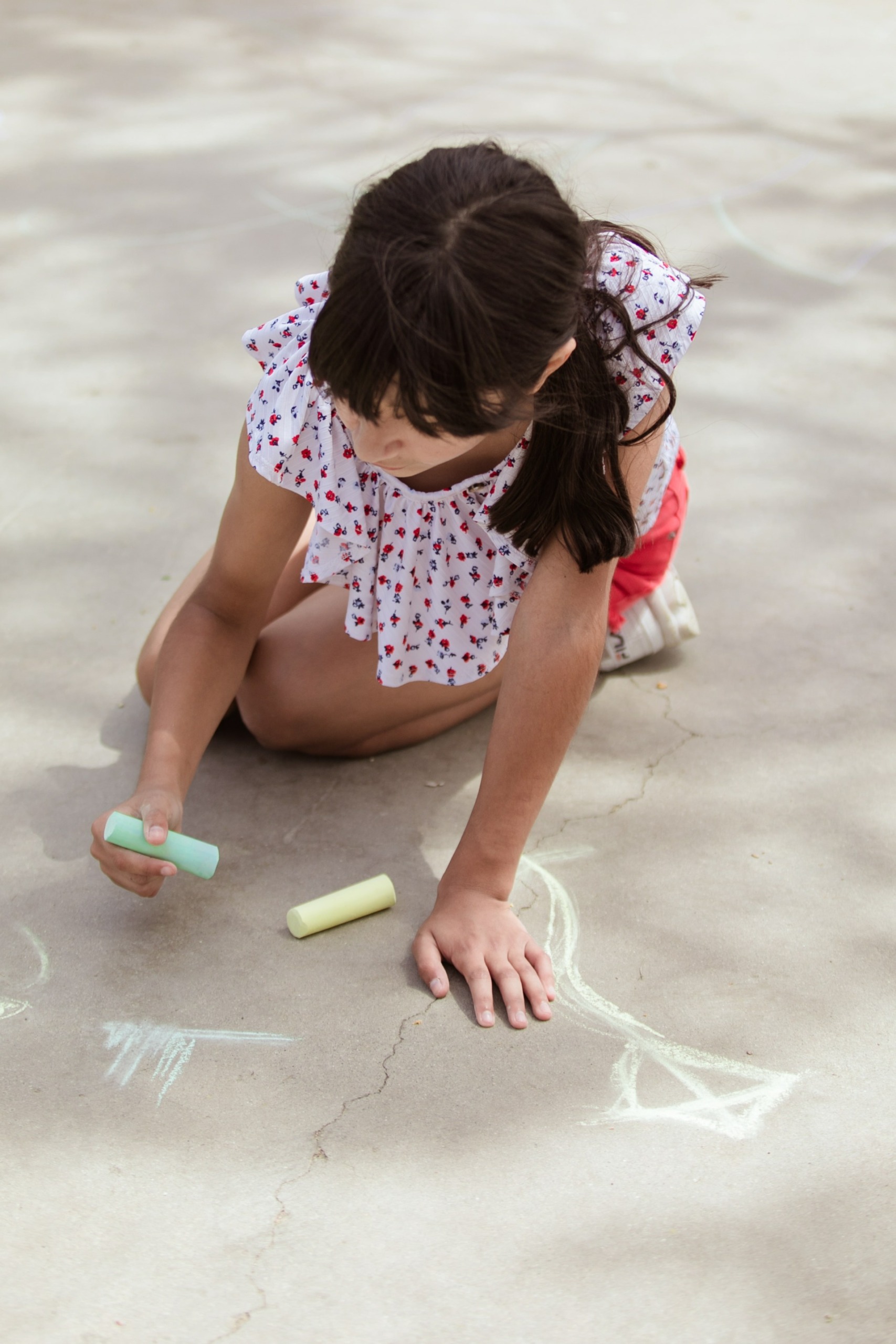 pexels-rodnae-productions-8035108 Little girl drawing with chalk on sidewalk